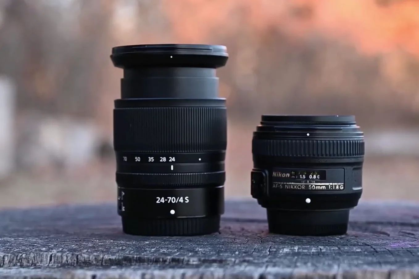 Comparison of Nikon Z 24-70mm f/4 S size next to a Nikon 50mm f/1.8G lens