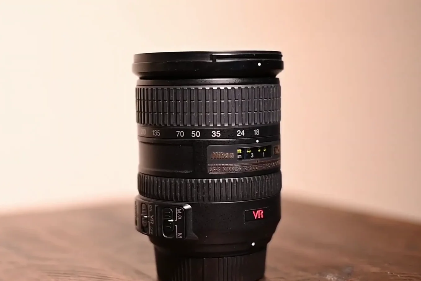 Nikon 18-200mm lens standing upright on table
