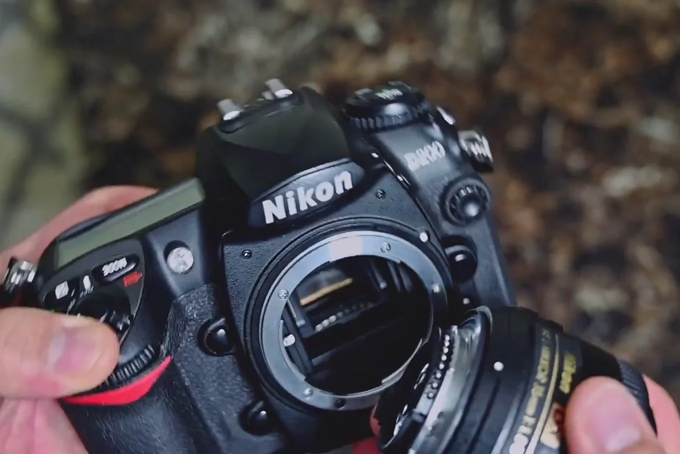 Nikon D200 with a 35mm lens attached sitting on a table