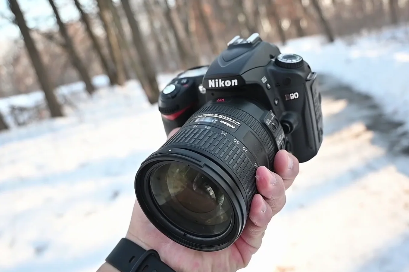 Nikon D90 sitting in the snow with a wide angle lens