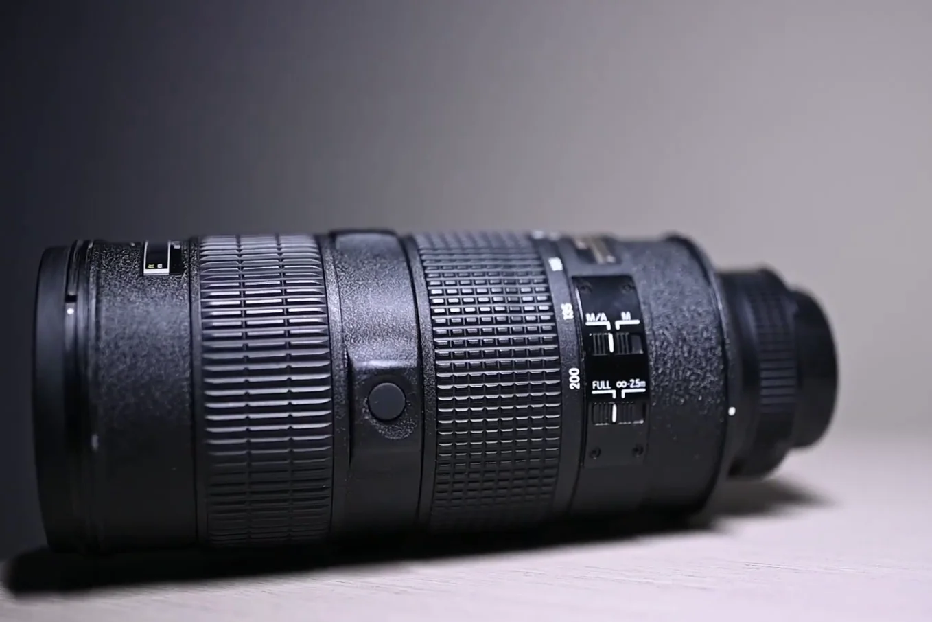 Side view of the lens barrel showing the focus limit switch and M/A switch