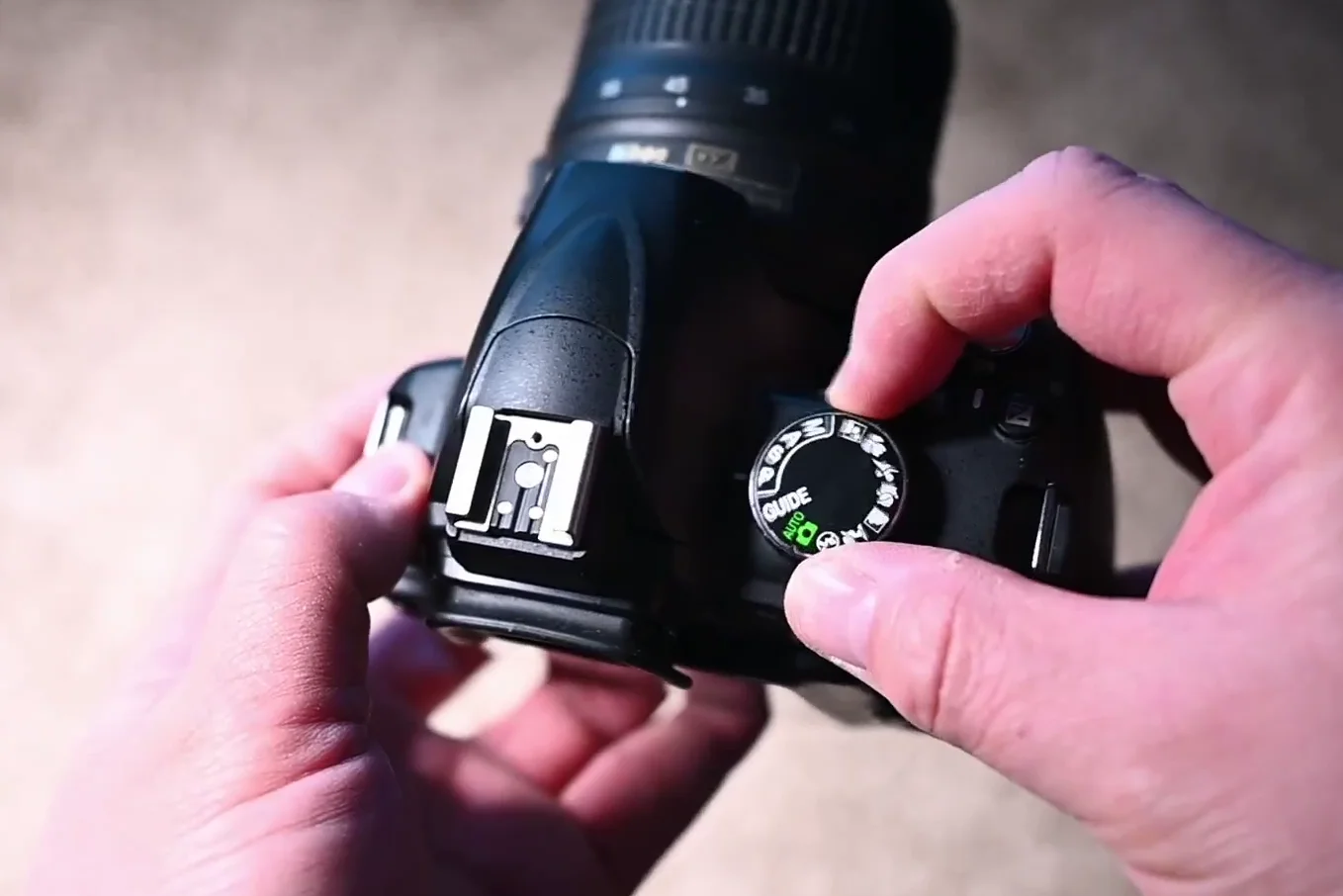 Top view of the camera showing the mode dial and guide mode