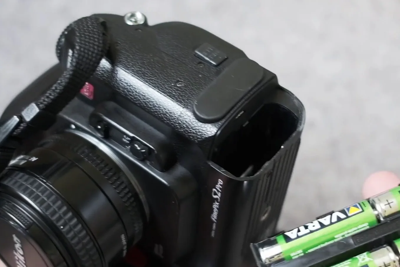 Battery compartment showing AA batteries and CR123 slots