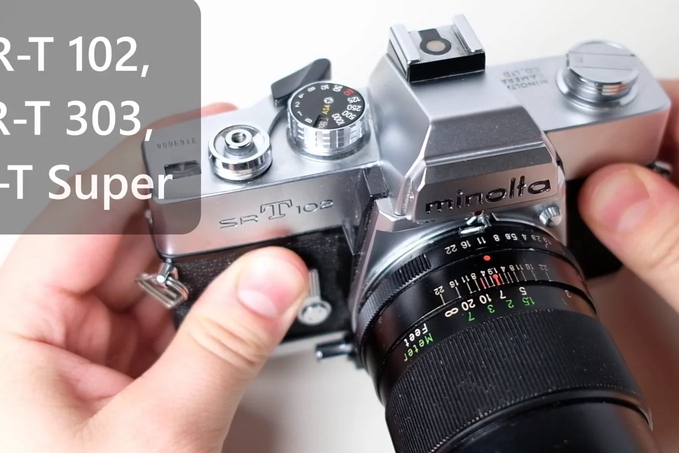 Minolta SR-T 102 camera held in hands showing the logo