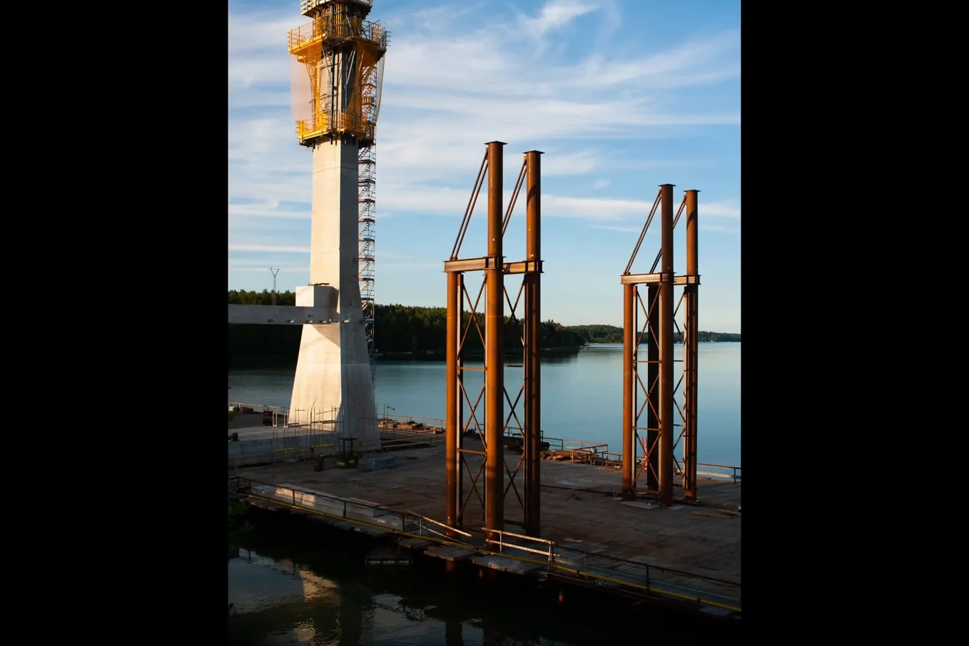 Vertical composition of bridge pylons under construction during golden hour