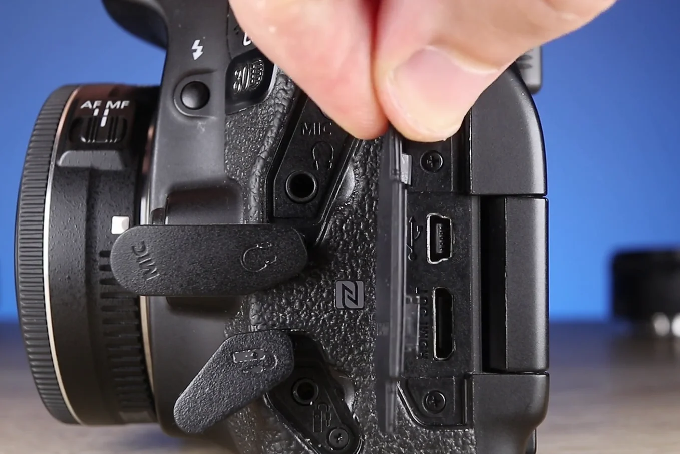 Side interface ports of the Canon 80D open showing mic and headphone jacks